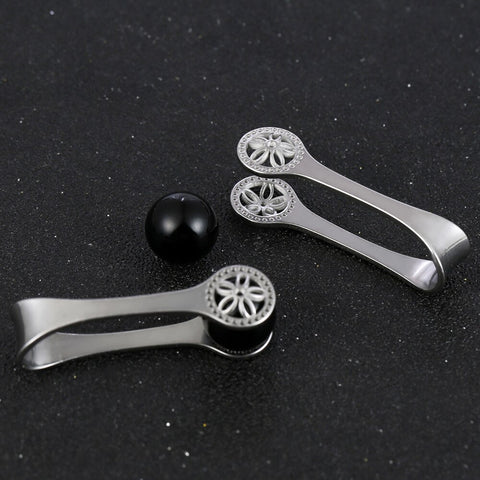 Silver ear weights with black beads for stretched lobes.