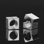 Silver ear stretching cube weights.