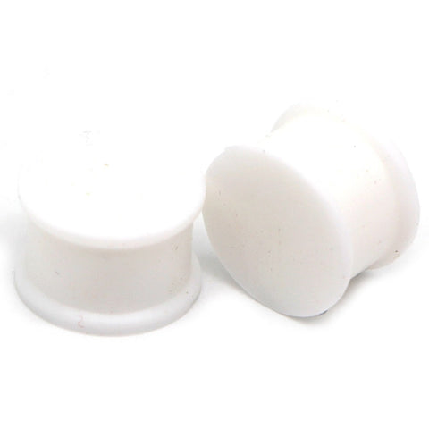 Large white silicone ear tunnels.