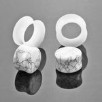 White Stone Ear Gauges with Silicone Ear Tunnels.