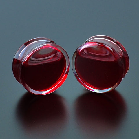 Clear ear plug gauges filled with red liquid. Sizes from 8mm to 25mm. Shop our ear plugs with free shipping to your doorstep.