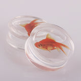 Liquid saddle goldfish ear plugs. Lobe gauges 8mm to 18mm. Free shipping to your doorstep. Checked for flaws and sold as pairs.