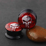 Punisher themed ear plug gauges 4mm to 16mm with free shipping to your doorstep. Ear lobe plugs with punisher logo, sold as pairs and checked for flaws.